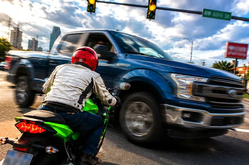 Pick-up truck turning left in front of a motorcycle rider at a busy Oklahoma City intersection causing a serious accident